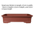 Large rectangular handmade purple clay bonsai pot on a garden table.