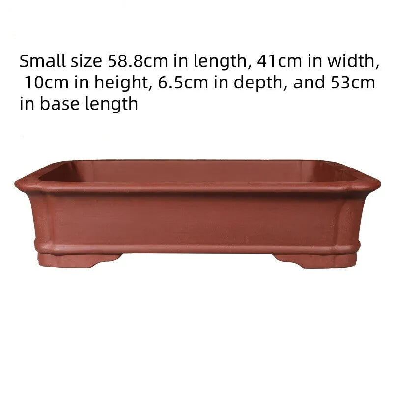 Large rectangular handmade purple clay bonsai pot on a garden table.