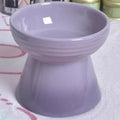 Black ceramic pet bowl with a high foot, neck protector rim, and stable base for dogs and cats.