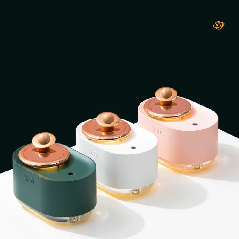 Green rotating planet-shaped USB humidifier with night light on wooden desk