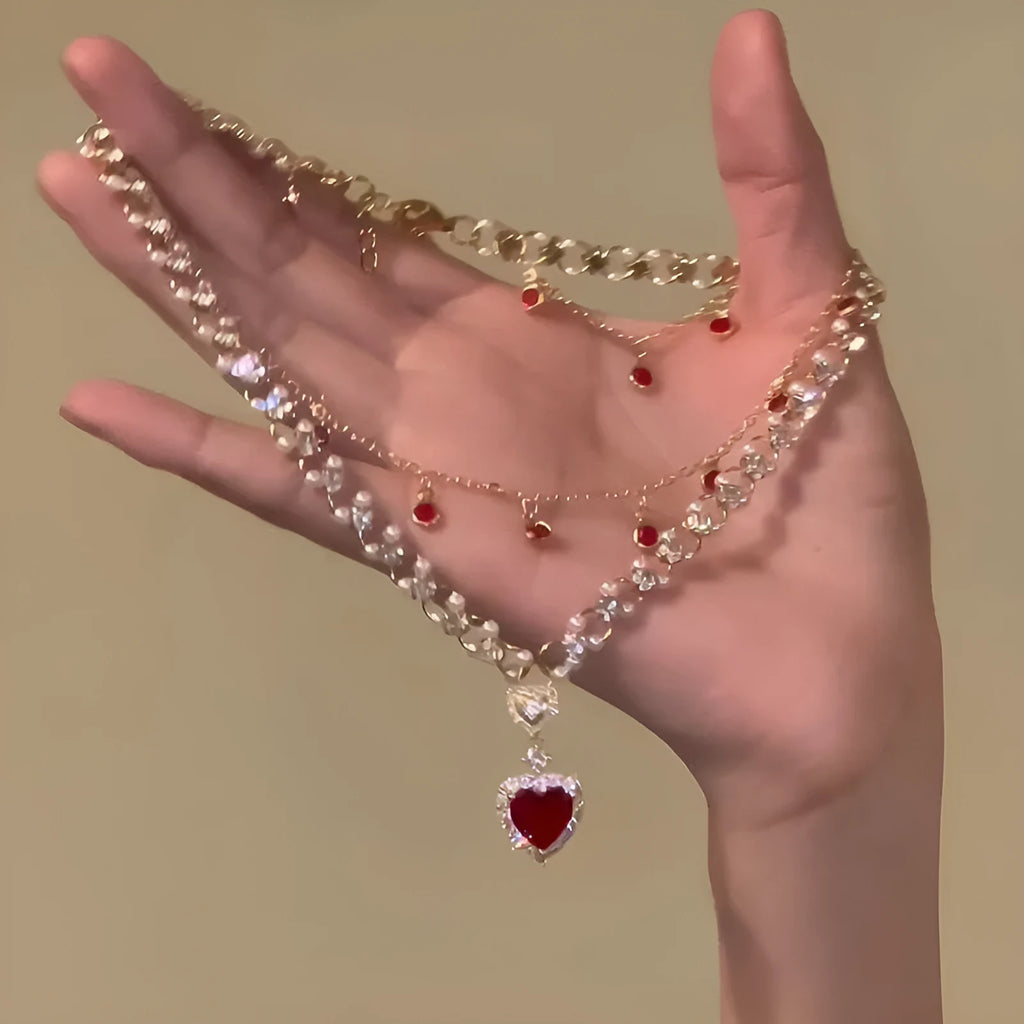 Red alloy double layer necklace with a love heart pendant on a regular chain.
