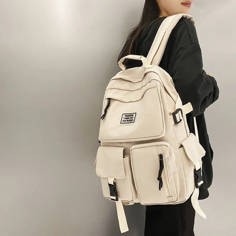 Black and white nylon student backpack with laptop compartment and 3D pockets.