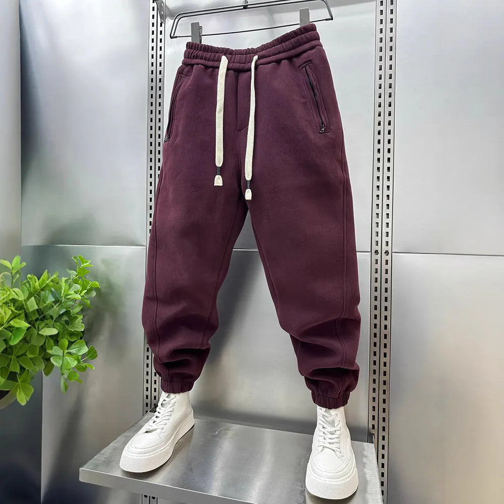Summer men's solid colour polyester track sweatpants with zippered pockets and ankle ties, black, side view
