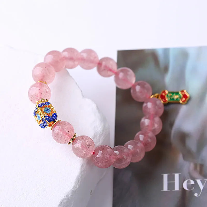 Pink strawberry quartz crystal bracelet with hand-woven construction and traditional Chinese ruyi lucky symbols