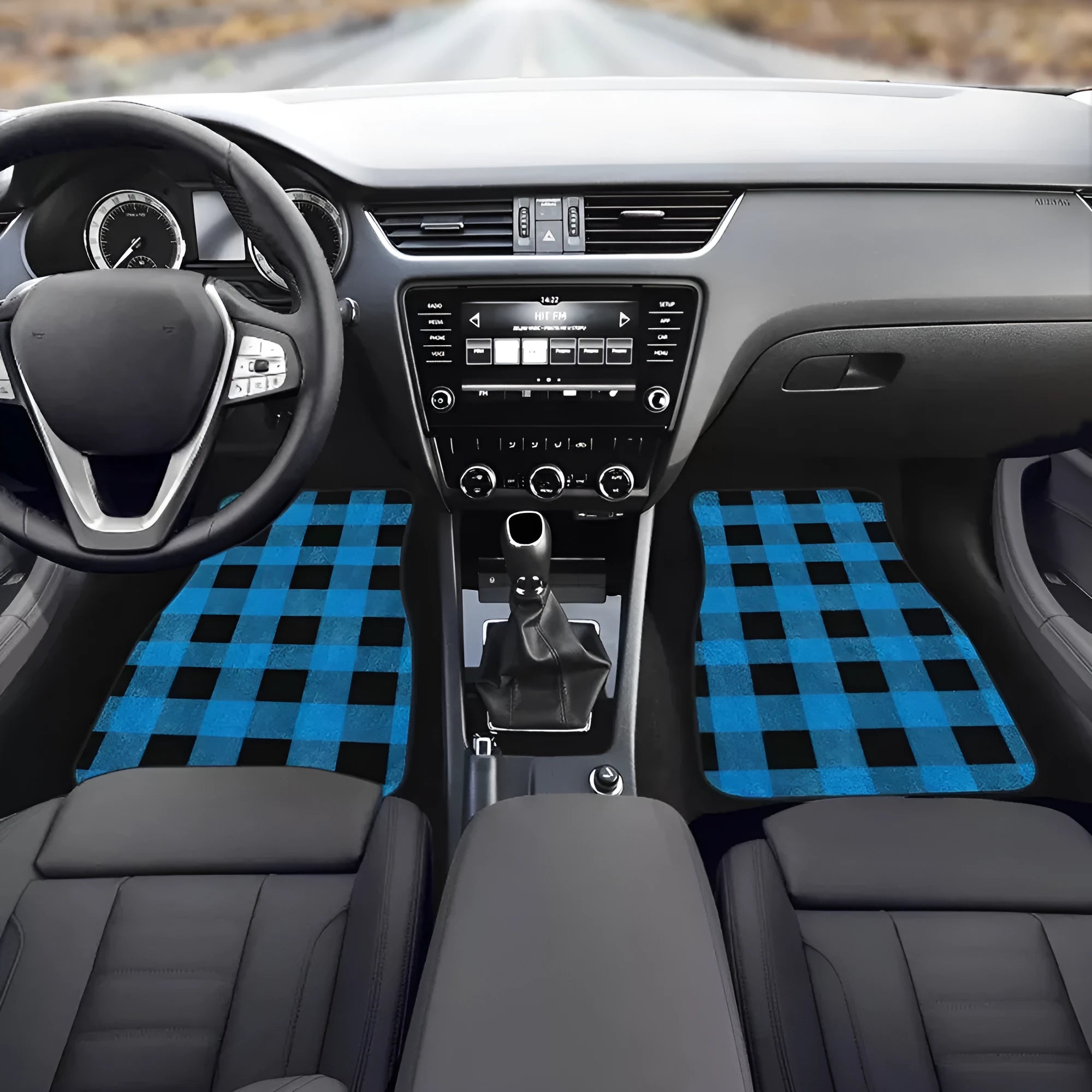 Four-piece set of black printed rubber car floor mats with textured surface.