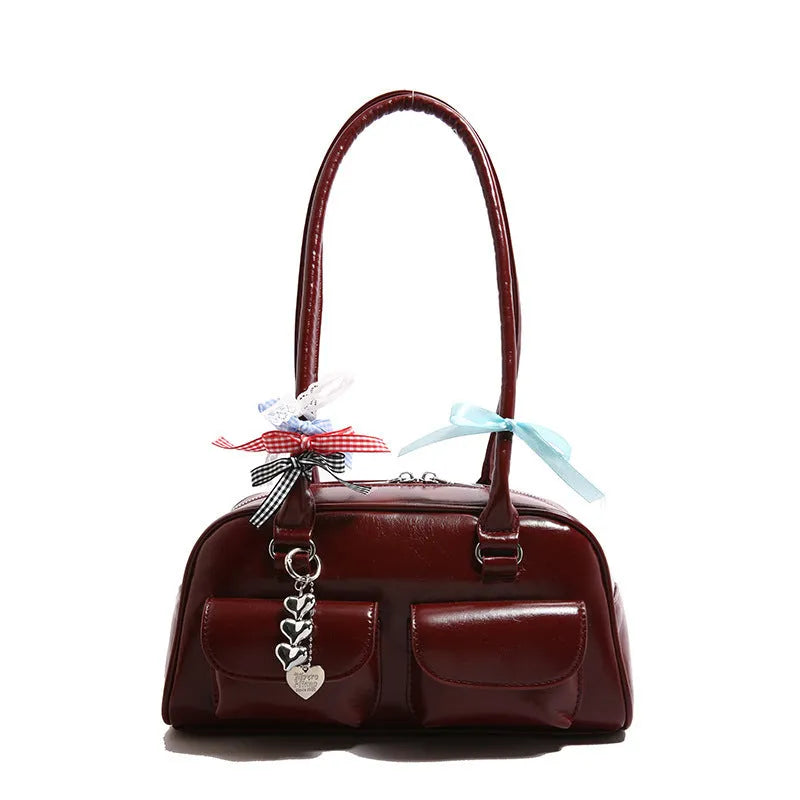 Retro pillow-shaped women's handbag in PU leather with a one shoulder strap, shown in a choice of colours.