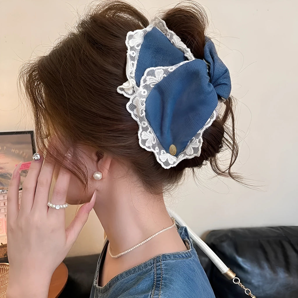 Handmade triangle-shaped hair clip for women in fabric and acrylic, showing plastic grip.