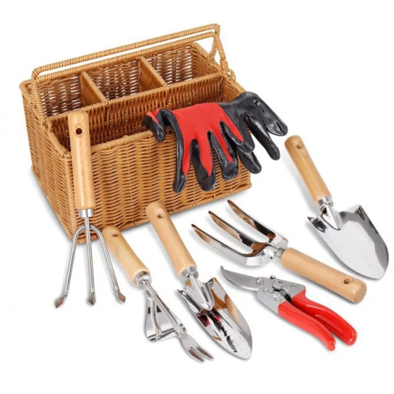 Gardening tools set with wooden handles and stainless steel hoe and shovel on rustic background