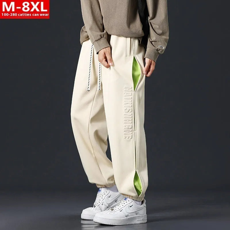 Men's grey green loose-fit cargo trousers with visible stitching detail and a banded ankle opening.