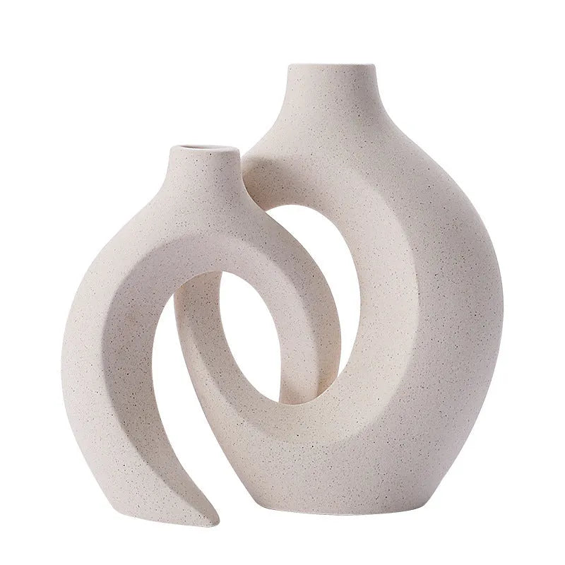 Two European ceramic vases with glazed snuggle colour finish, set on a shelf for creative home decoration