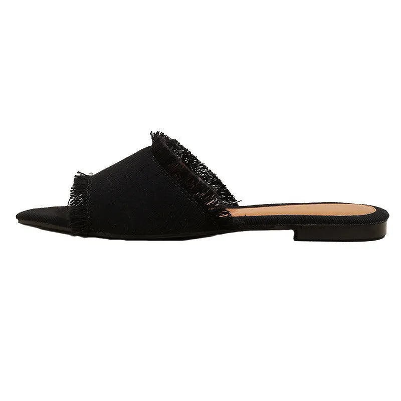 Women's denim flat slipper with tassel detail, leather lining, and a solid colour option.