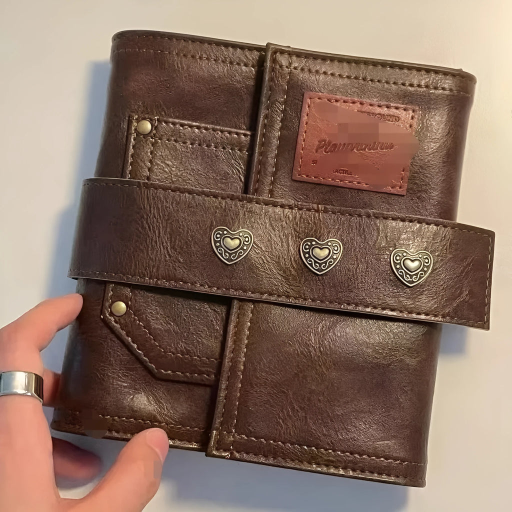 Brown retro-style A7 notebook with a PU cover and leather buckle, shown open to reveal loose-leaf binding.
