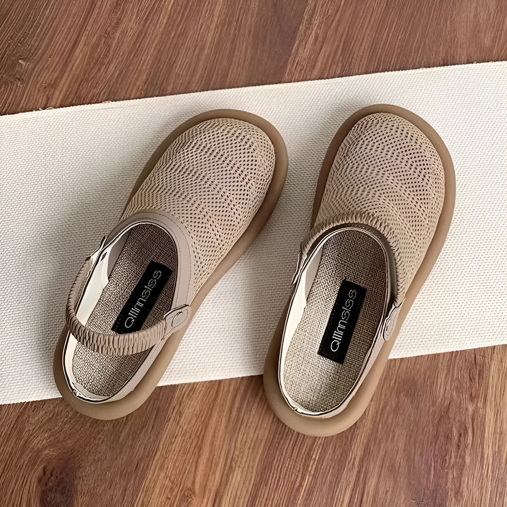 Milky white linen slip-on hole shoes with mesh lining and a light brown rubber sole, shown from the side.