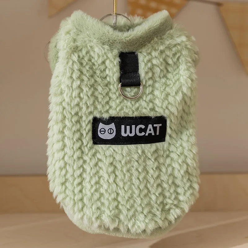 Two-legged sleeveless fleece dog vest with integrated leash ring in soft green or neutral beige, sizes XS to XL