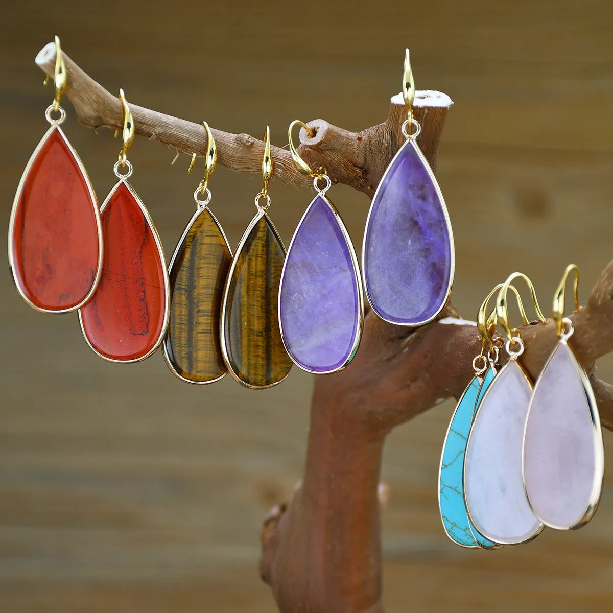 Vintage long water drop earrings in tigereye stone with textured surface and dangle silhouette