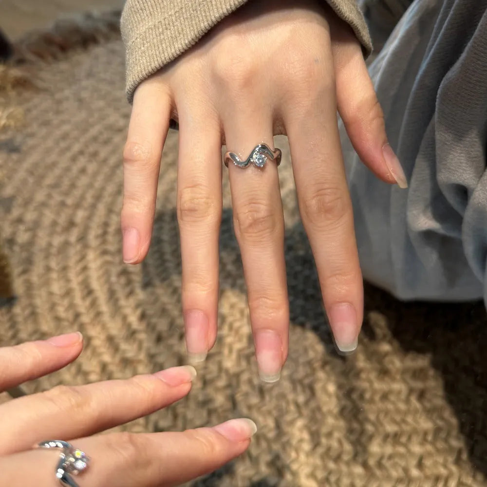 Women's silver electroplated open ring with single diamond and smooth wave line design, white gold tone