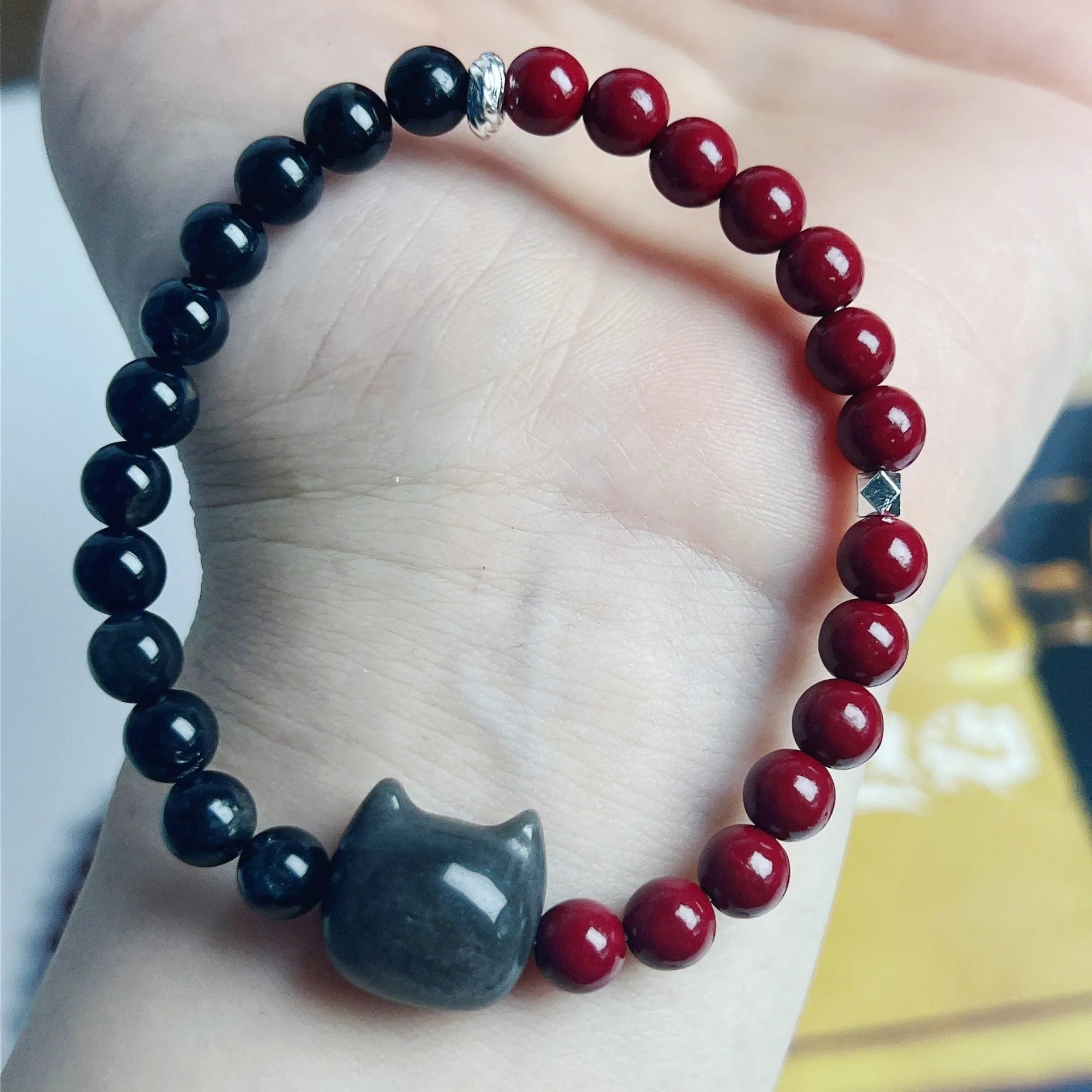 Handmade obsidian gemstone bracelet with cat charm on black elastic cord