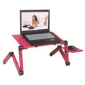 Black folding metal computer desk with cooling fan and laptop in use.