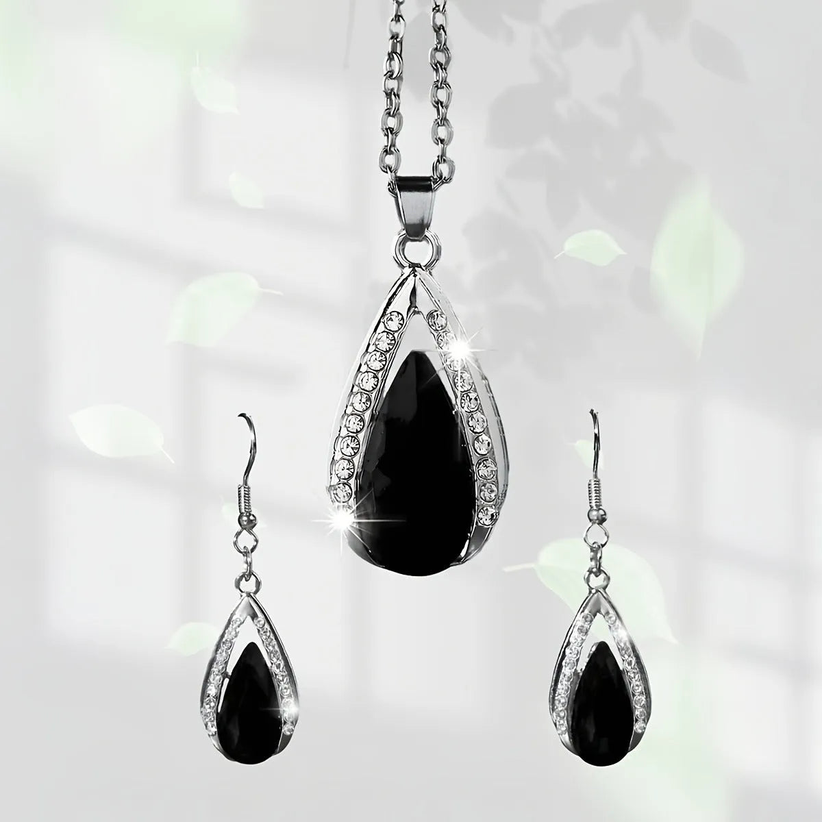 Black and red teardrop glass pendant necklace and matching alloy earrings set.