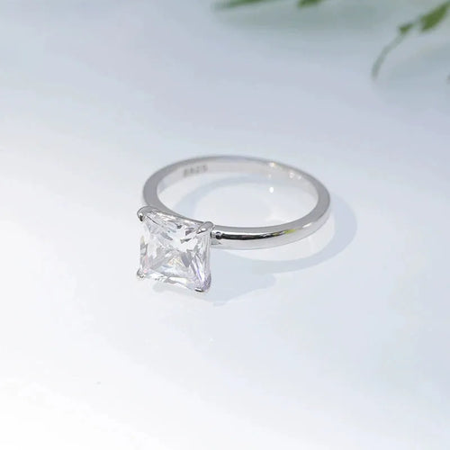 Women's geometric sterling silver ring in gold, rose gold, or silver on a grey background.