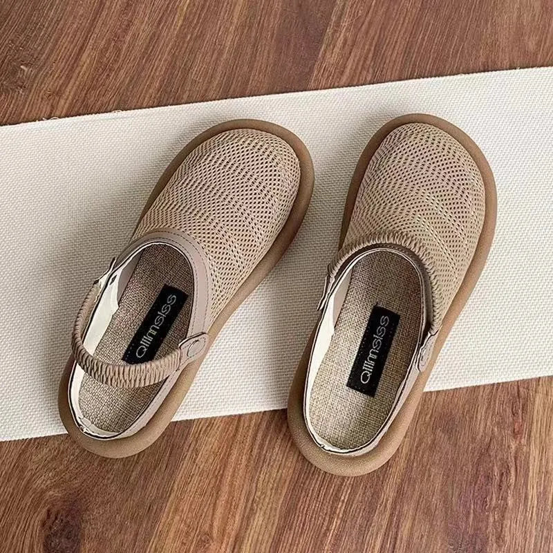 Milky white linen slip-on hole shoes with mesh lining and a light brown rubber sole, shown from the side.