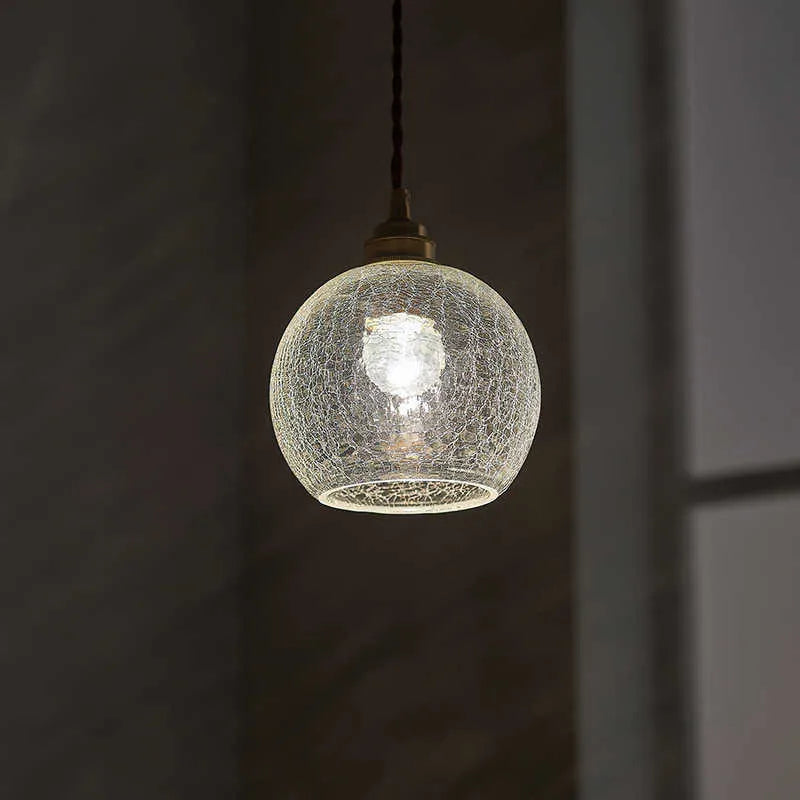 Retro brass ceiling chandelier with a clear glass ball shade, showing copper construction.