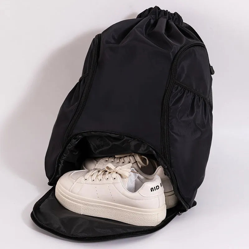 Large black cube-shaped sports backpack with drawstring closure for travel and fitness use