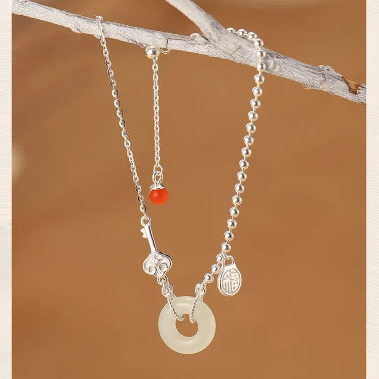 Silver bracelet with geometric peace buckle charm containing Hetian jade, traditional Chinese women's jewellery