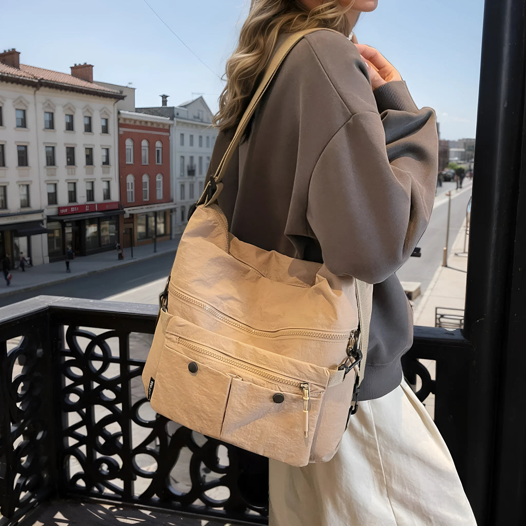 Women's nylon crossbody bag in square vertical shape with double shoulder straps and organised interior compartments