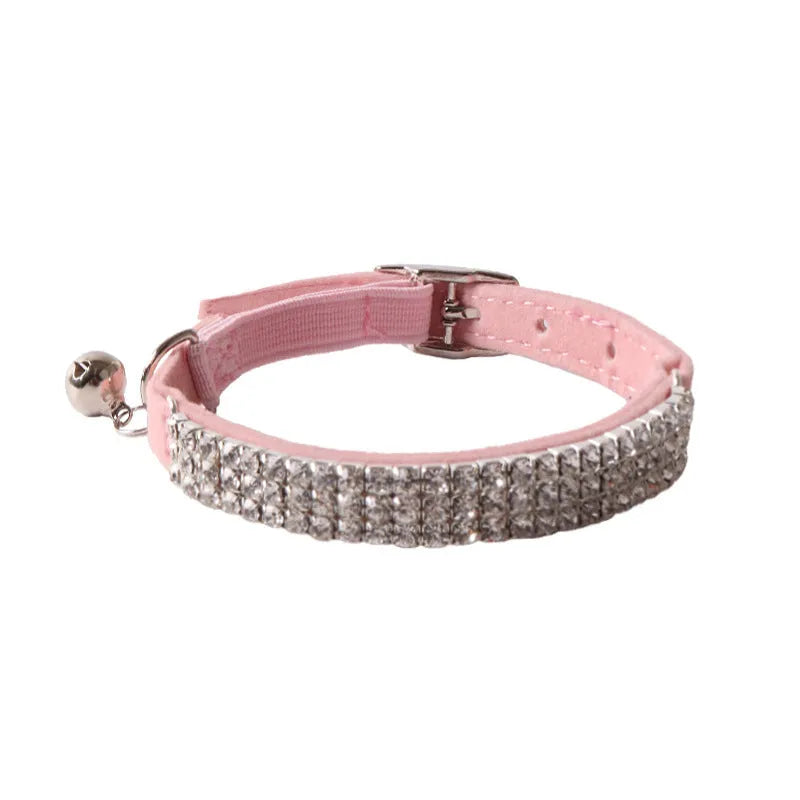 Pink flannel cat collar with elastic buckle and gang drill pattern lying flat.