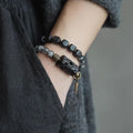 Ethnic style black hair crystal mixed handmade texture bracelet on a neutral background