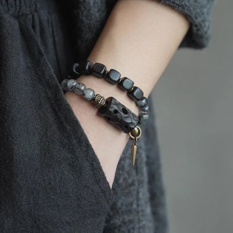 Ethnic style black hair crystal mixed handmade texture bracelet on a neutral background