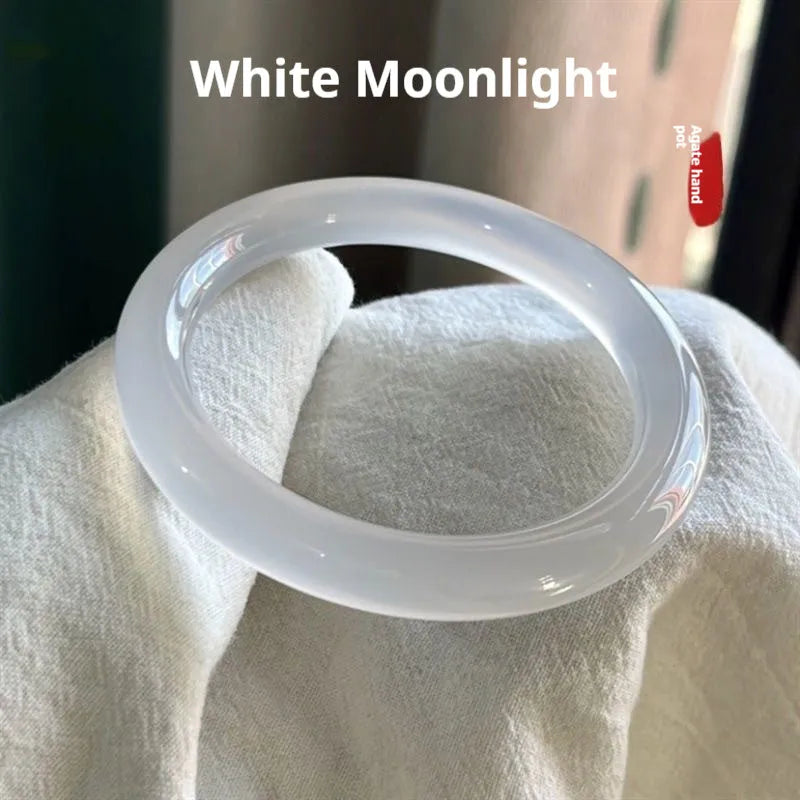Natural agate wide tyre bracelet in a selection of colours including pink, blue, and green on a size chart showing 52mm to 62mm.