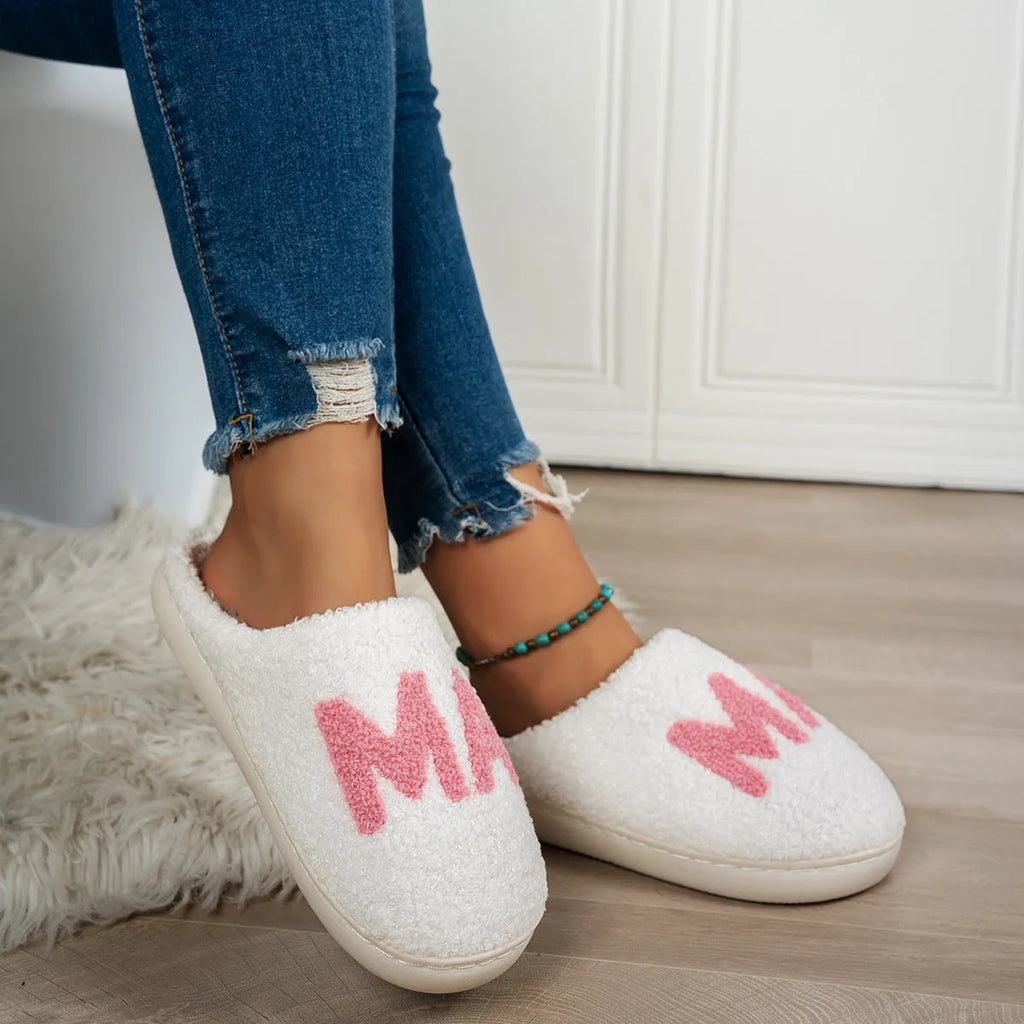 White plush cotton slippers with non-slip TPR sole on indoor floor