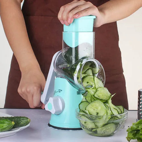 Blue round manual mandoline kitchen slicer with stainless steel blade on a countertop.