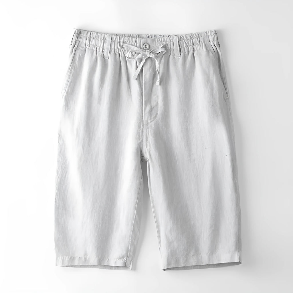 Men's loose-fitting linen capri pants in a light colour, showing the straight-leg style.