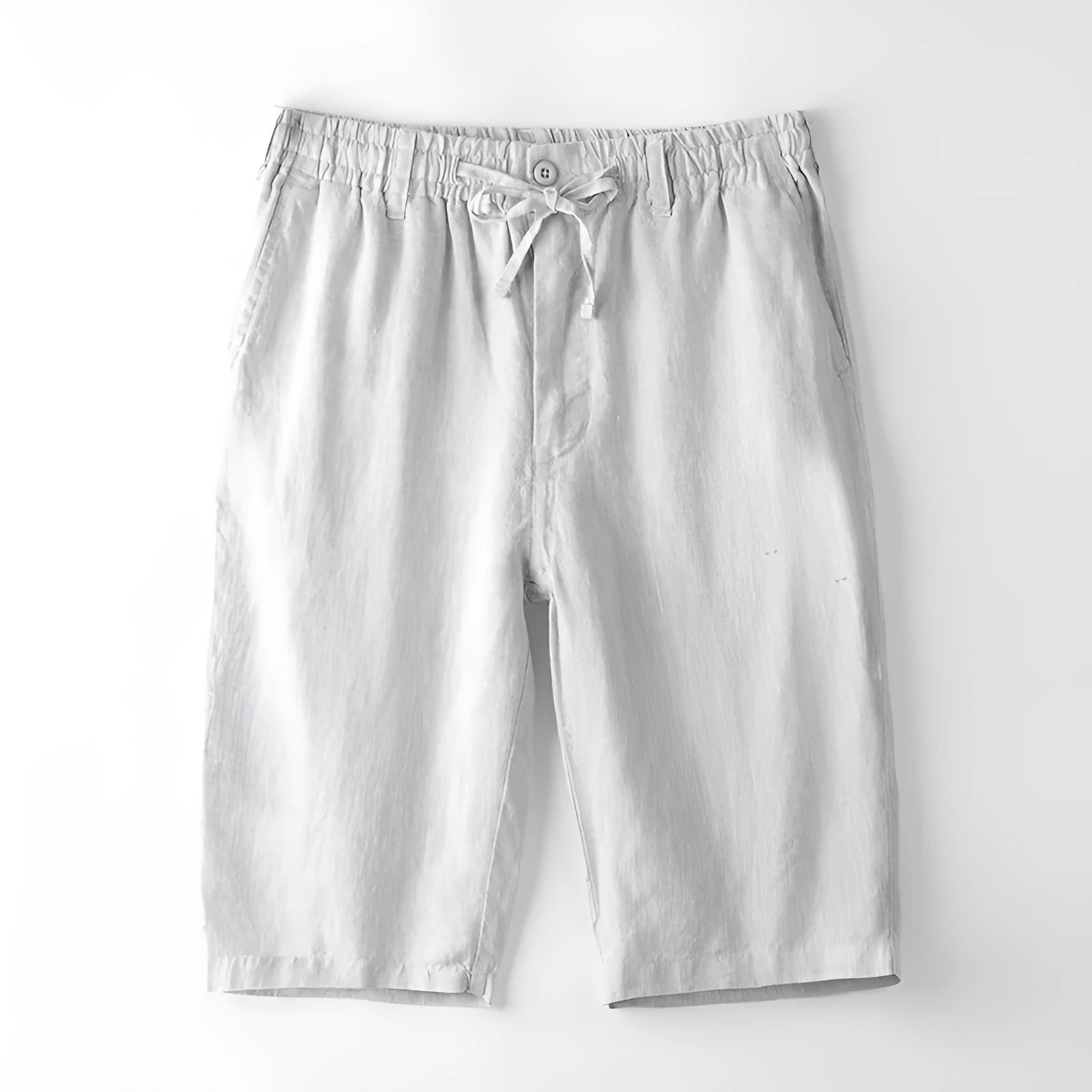 Men's loose-fitting linen capri pants in a light colour, showing the straight-leg style.