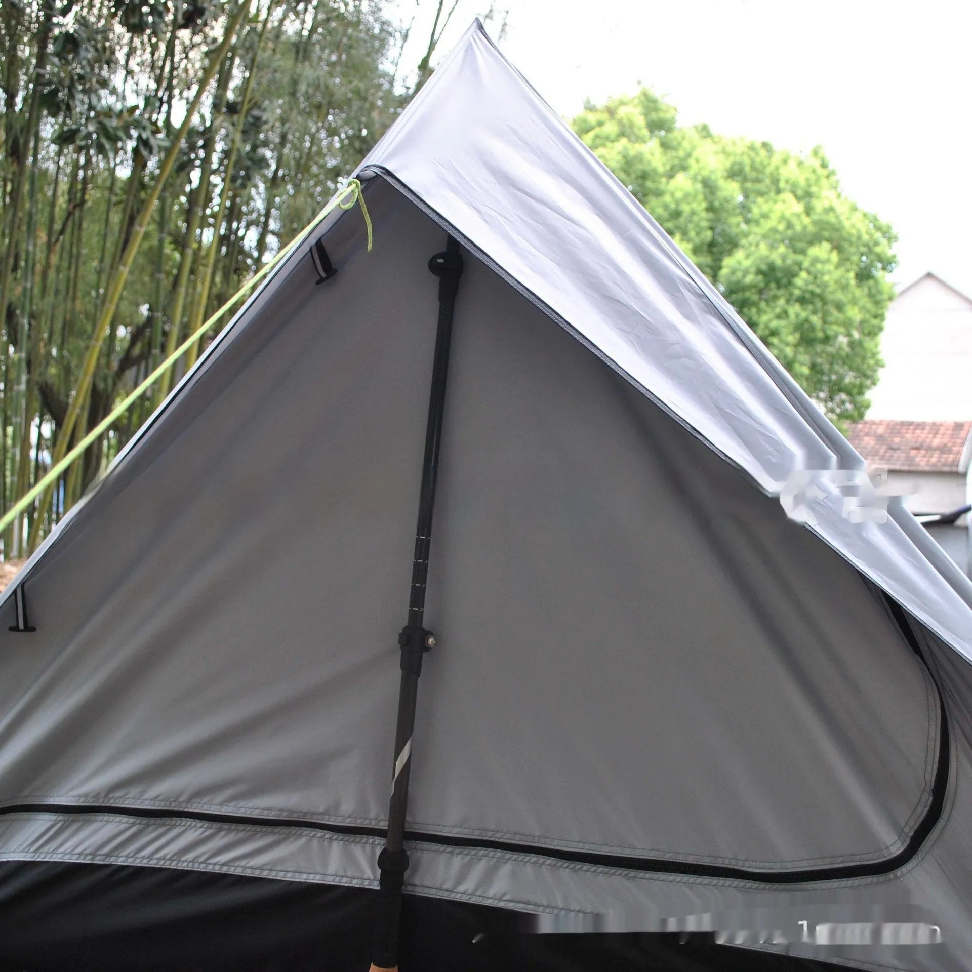 Brown A-line pole-free tent erected with hiking canes showing 2-3 person capacity and waterproof fabric construction