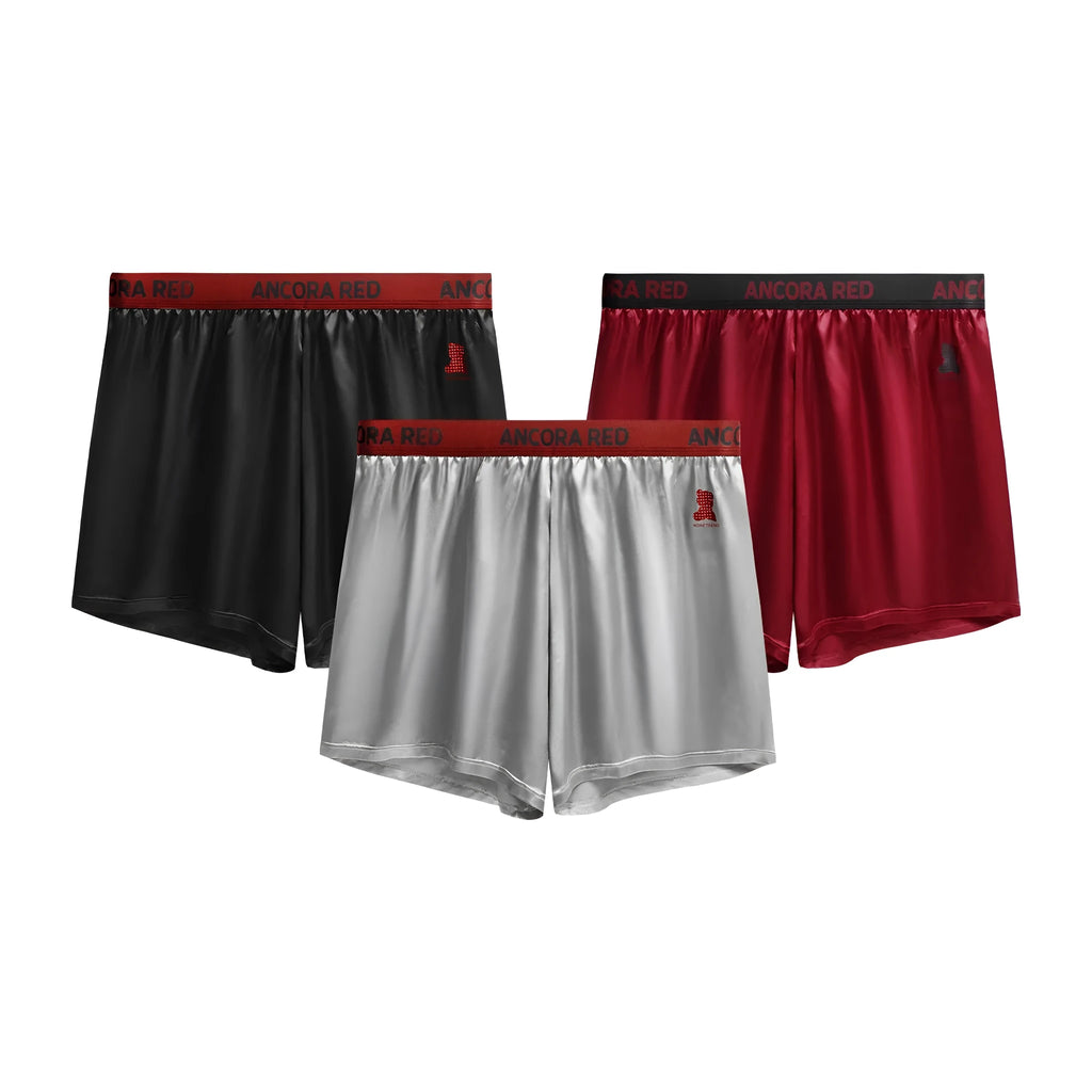 Solid colour men's polyester boxer briefs on a mid-waist, shown in black, blue, brown, purple, red, and silver.