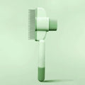 Green and yellow dog grooming brush with one-click hair removal and anti-mite function
