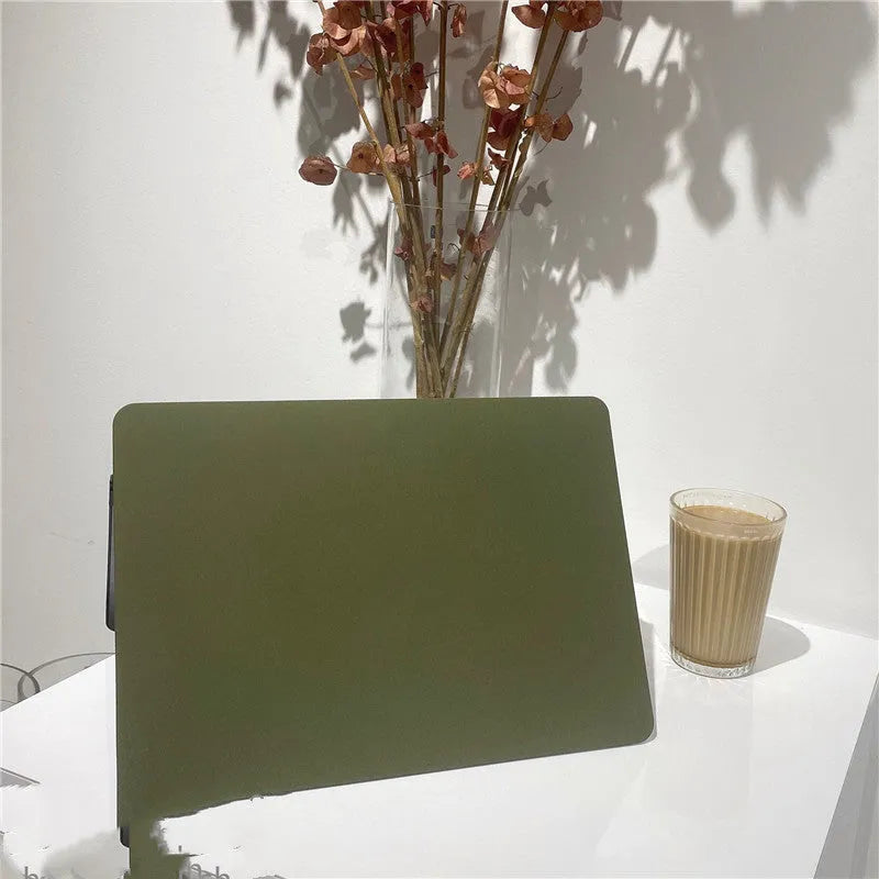Quicksand army green polycarbonate MacBook protective shell on a laptop showing textured finish.