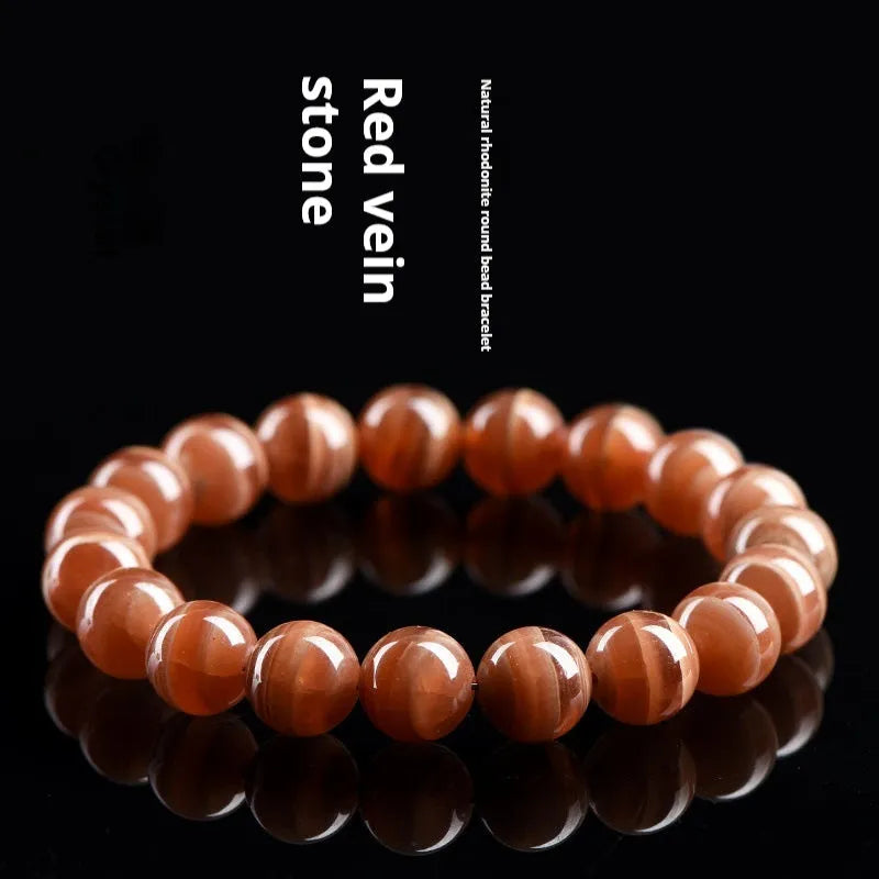 Natural old mine rhodochrosite round bead bracelet with Ruyi charm, shown in 6mm and 8mm sizes.