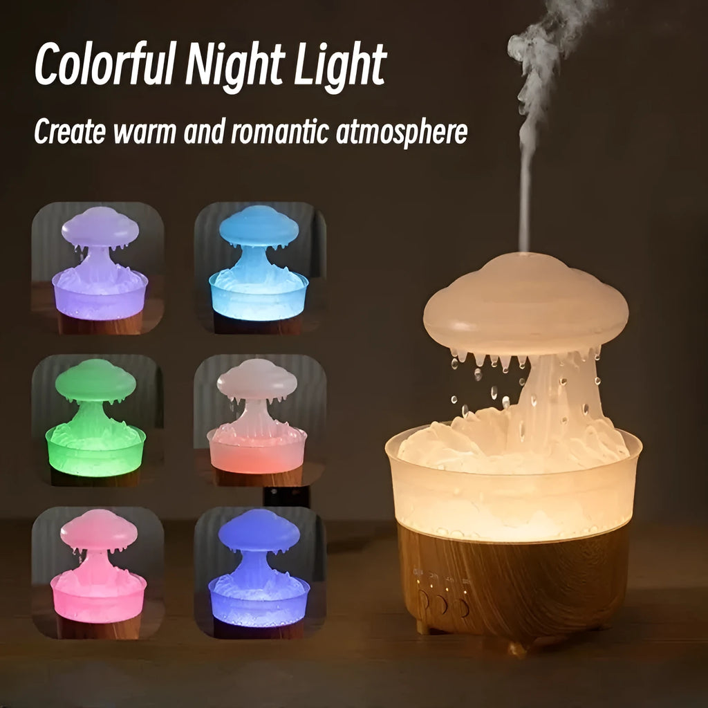 Wood grain white cloud-shaped humidifier diffuser with LED lights and water drop rain effect on a table.