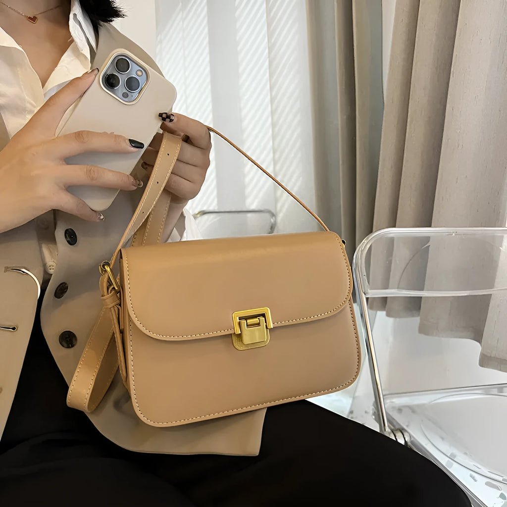 Soft black PU leather women's square cross-body bag with textured finish shown on model.
