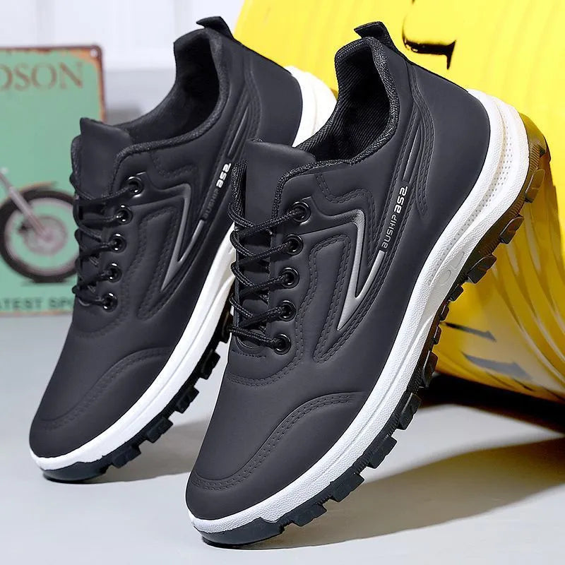 Black and grey low-top waterproof casual shoes with a lace-up front and plastic sole.