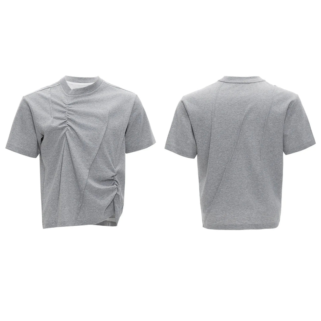 Man wearing a grey pleated cotton t-shirt with a round neck and loose fit.