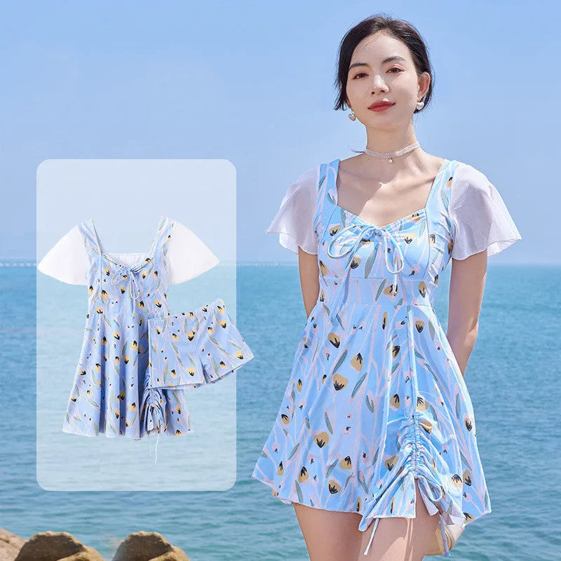 Women's sea salt blue floral one-piece polyester swimsuit on a hanger.