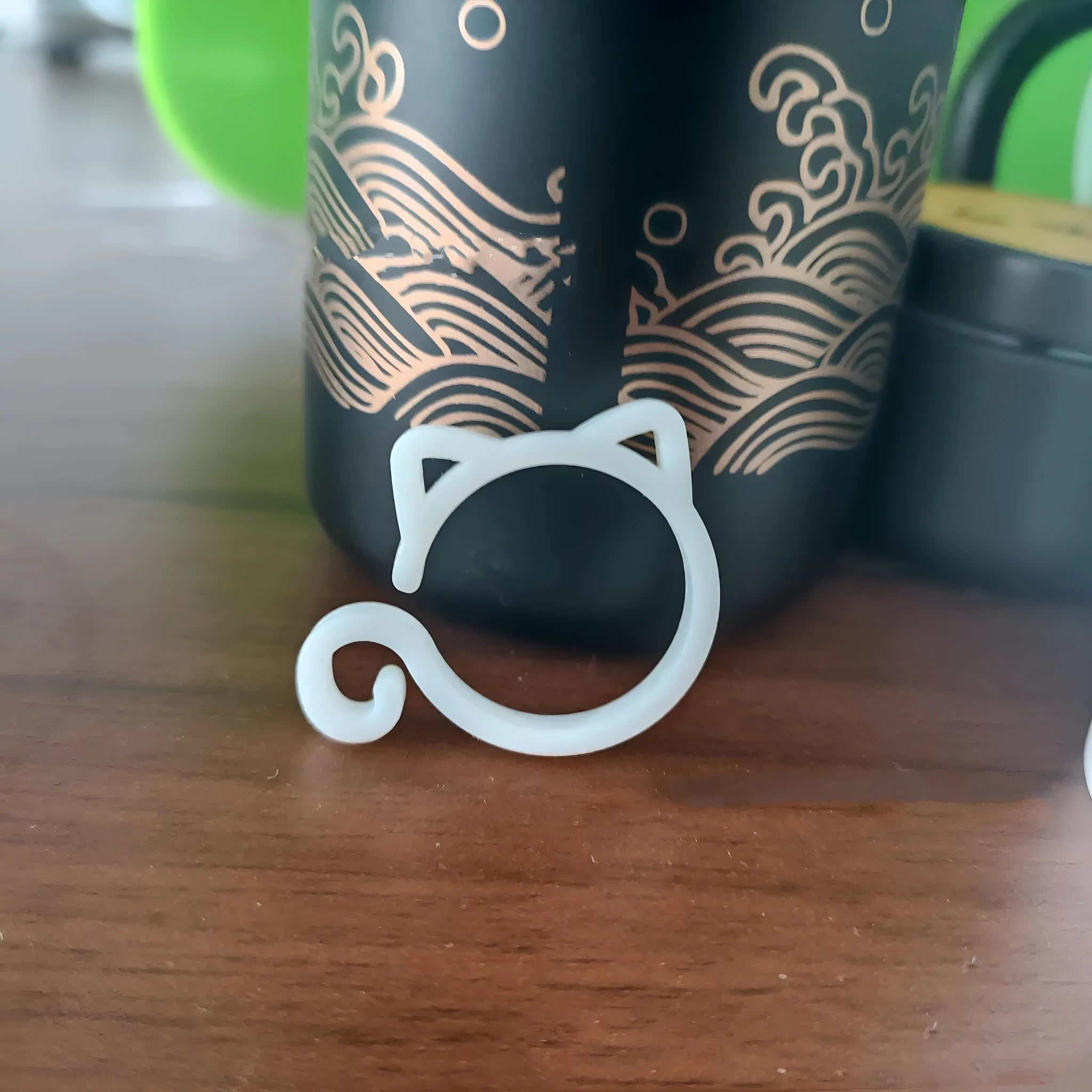 Colourful cat-shaped plastic plant clip for garden use on a white background.