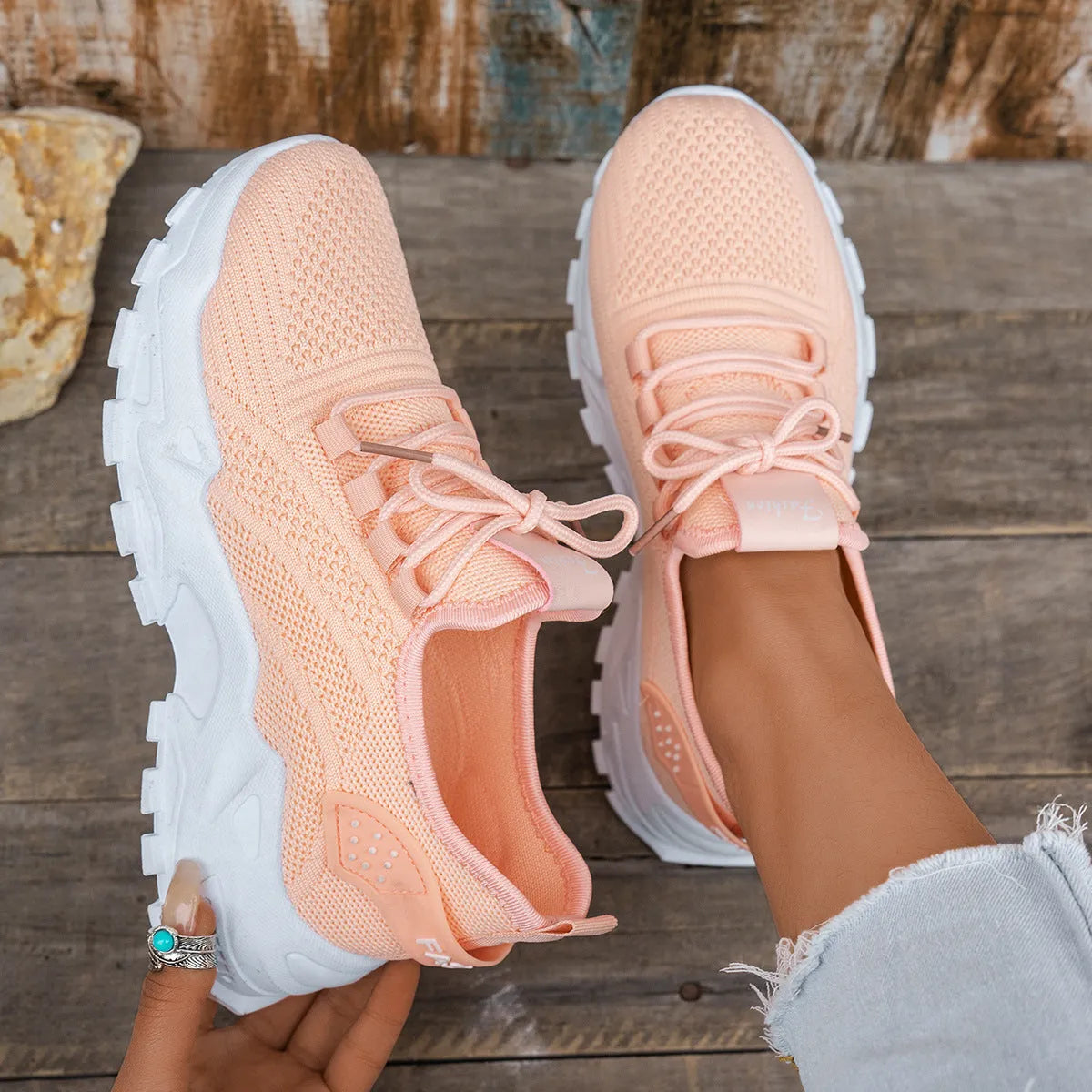 Women's white Flyknit mesh sports casual shoes with flat heel and lace-up front.