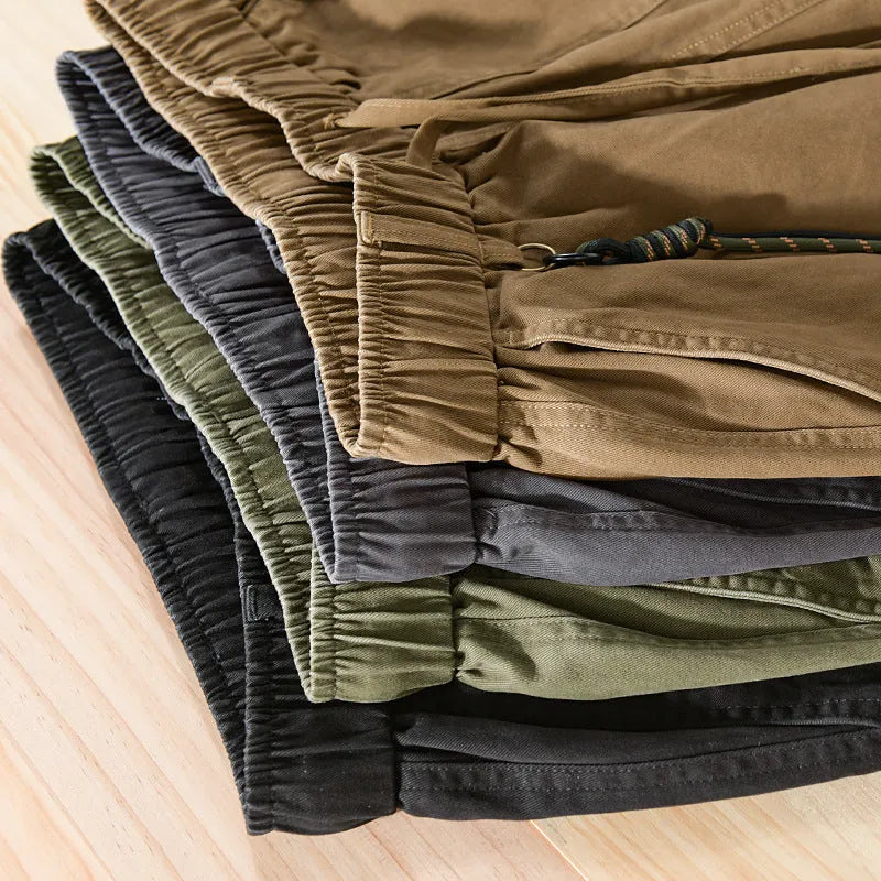 Men's army green cotton overalls with drawstring waist and ankle-band legs on a plain background.